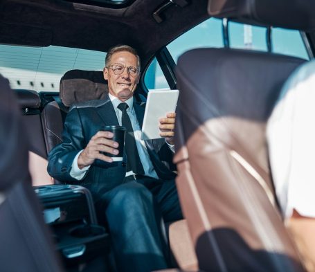 Business passenger in private hire vehicle Birmingham airport transfer service